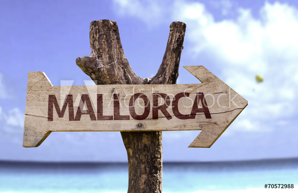 Mallorca wooden sign with a beach on background
