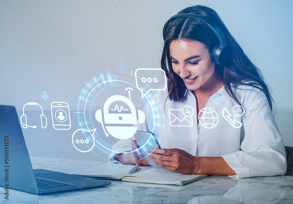 Businesswoman with smartphone, computer and digital bot hologram