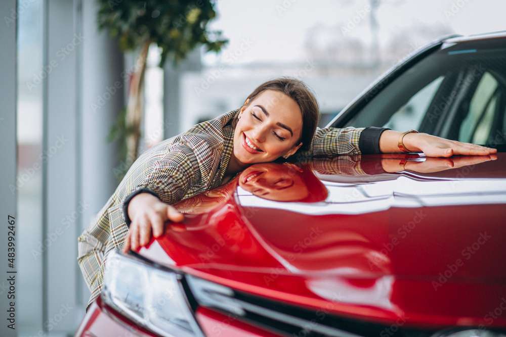 Beautiful woman hugging a car
